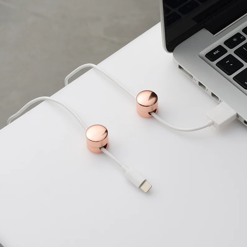 Elegant cord organization systems: Love these simple weighted metallic cord keepers for your desktop found on Etsy