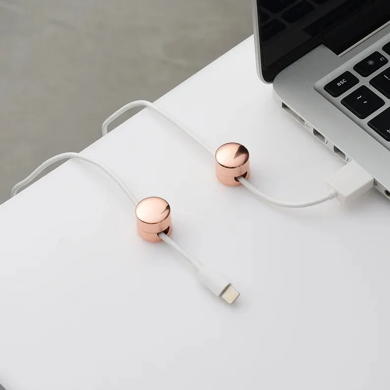Elegant cord organization systems: Love these simple weighted metallic cord keepers for your desktop found on Etsy